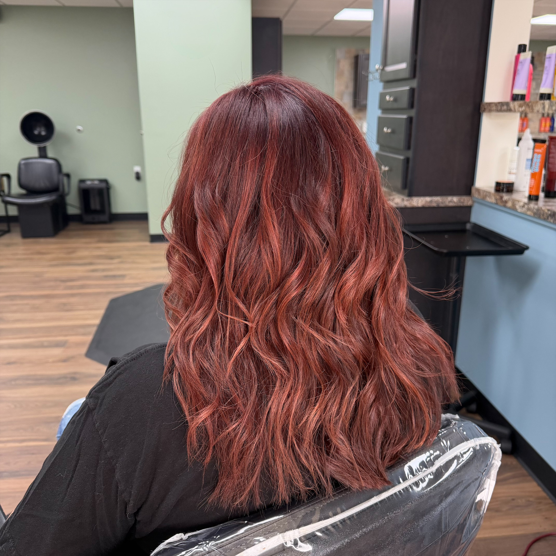 Copper red wavy hair color at Favero's Hair Salon