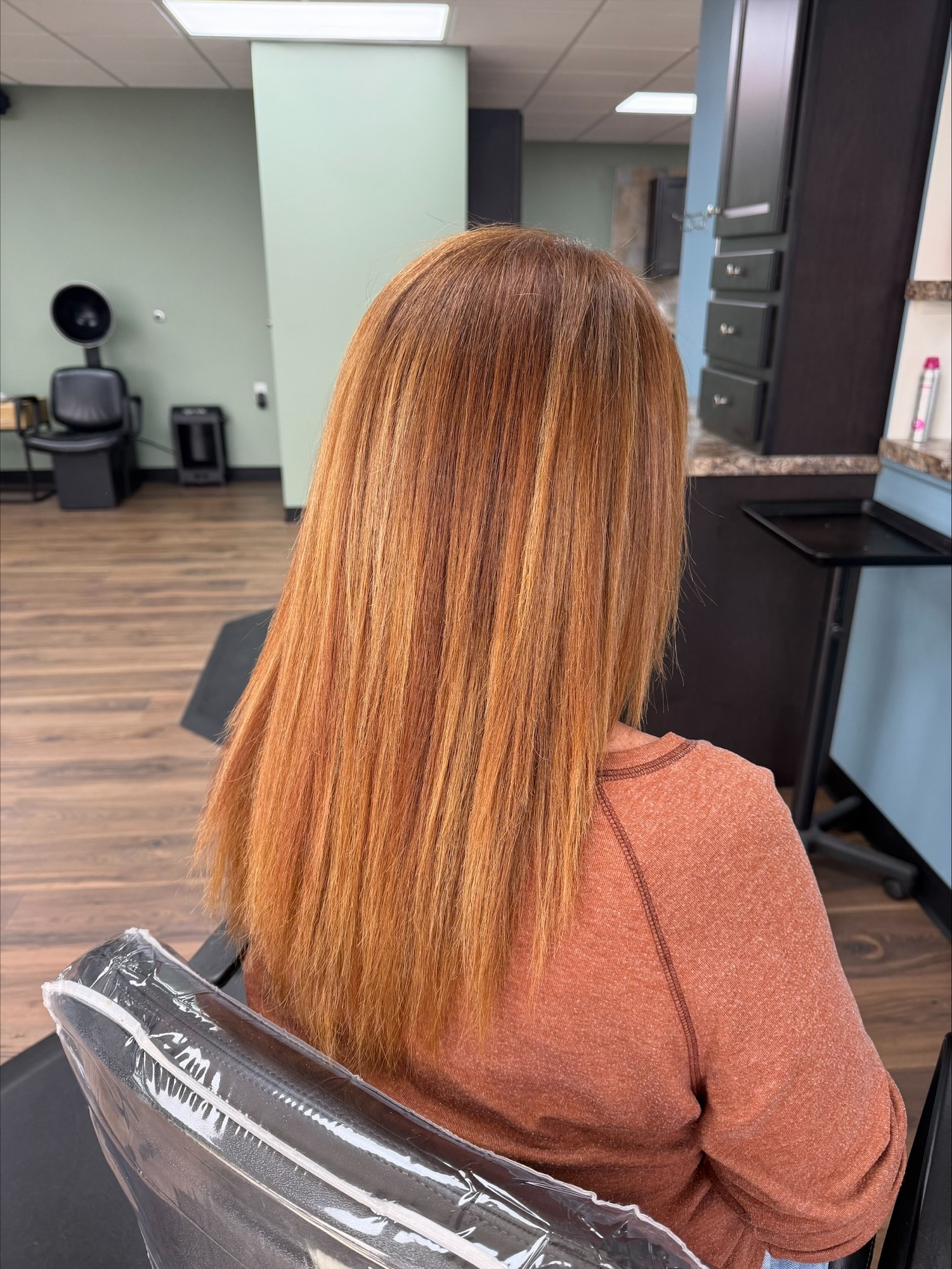 Copper red straight hairstyle at Favero's Hair Salon