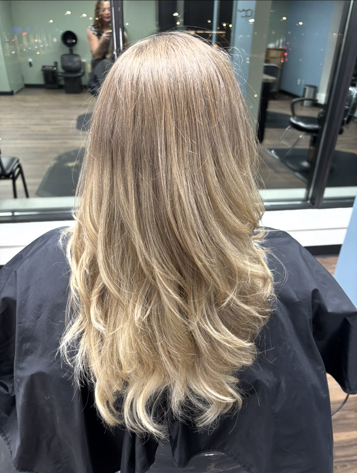Long blonde curled hairstyle at Favero's Hair Salon