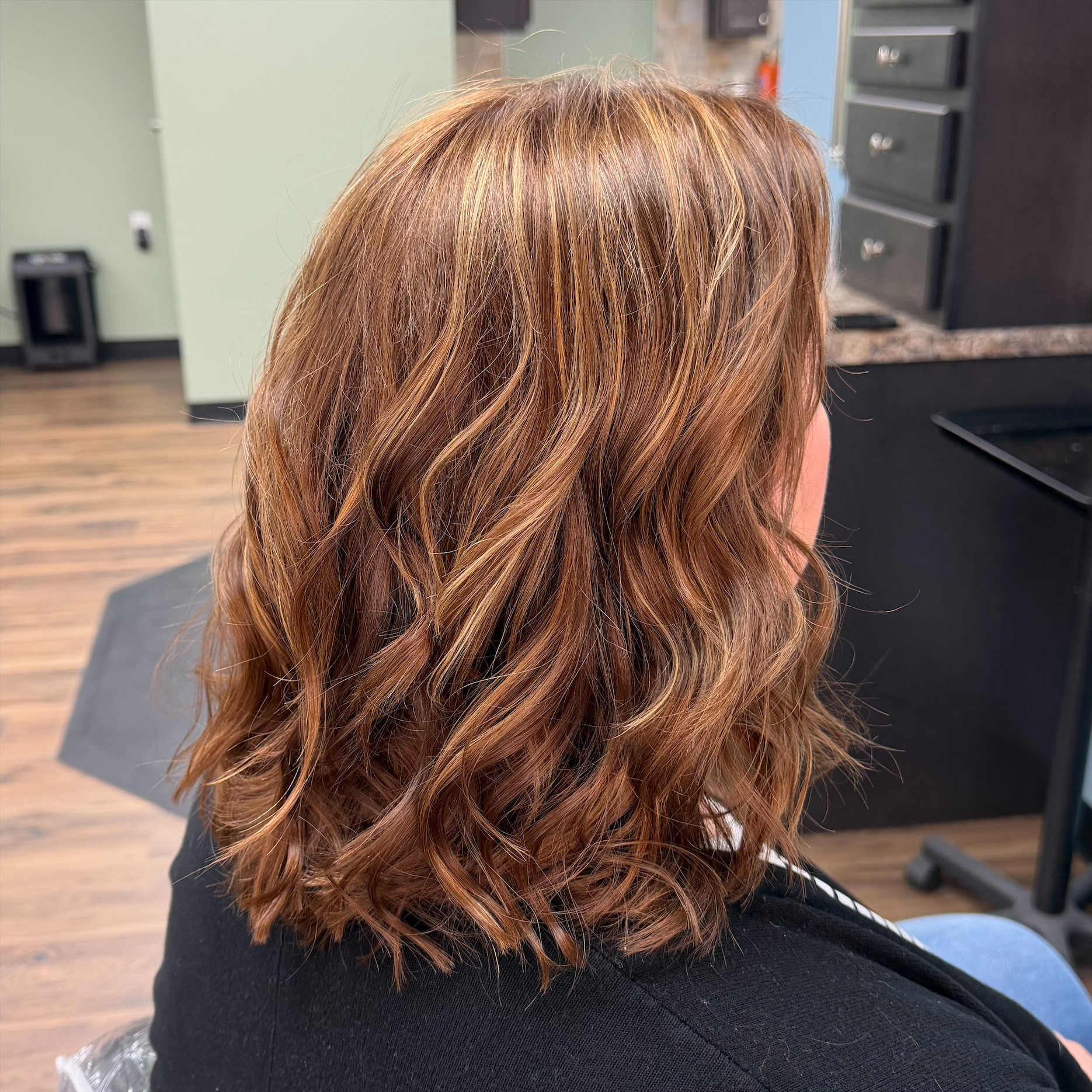 Wavy dimensional copper hairstyle at Favero's Hair Salon