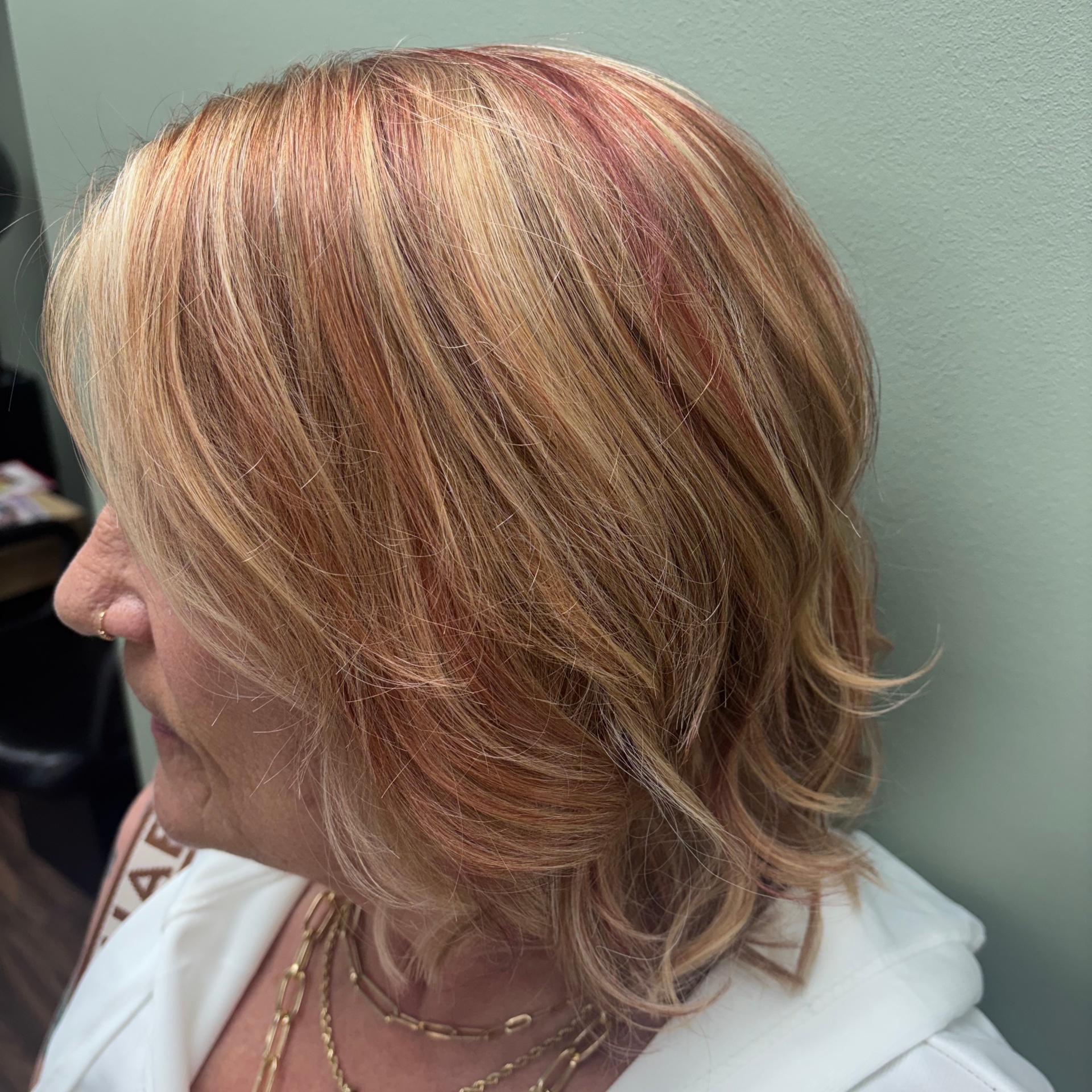 Strawberry blonde with rose highlights at Favero's Hair Salon