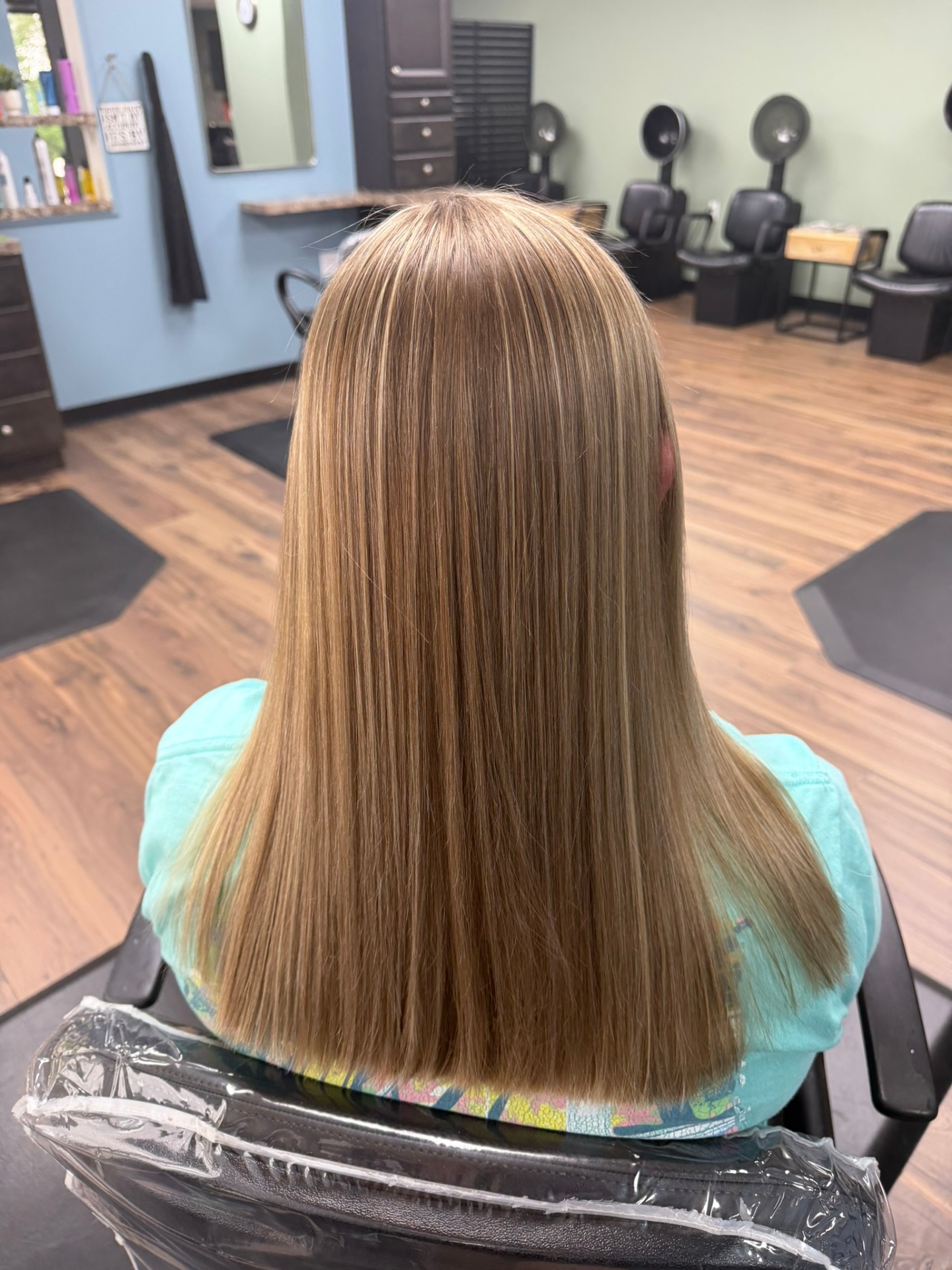 Long honey blonde straight hair at Favero's Hair Salon