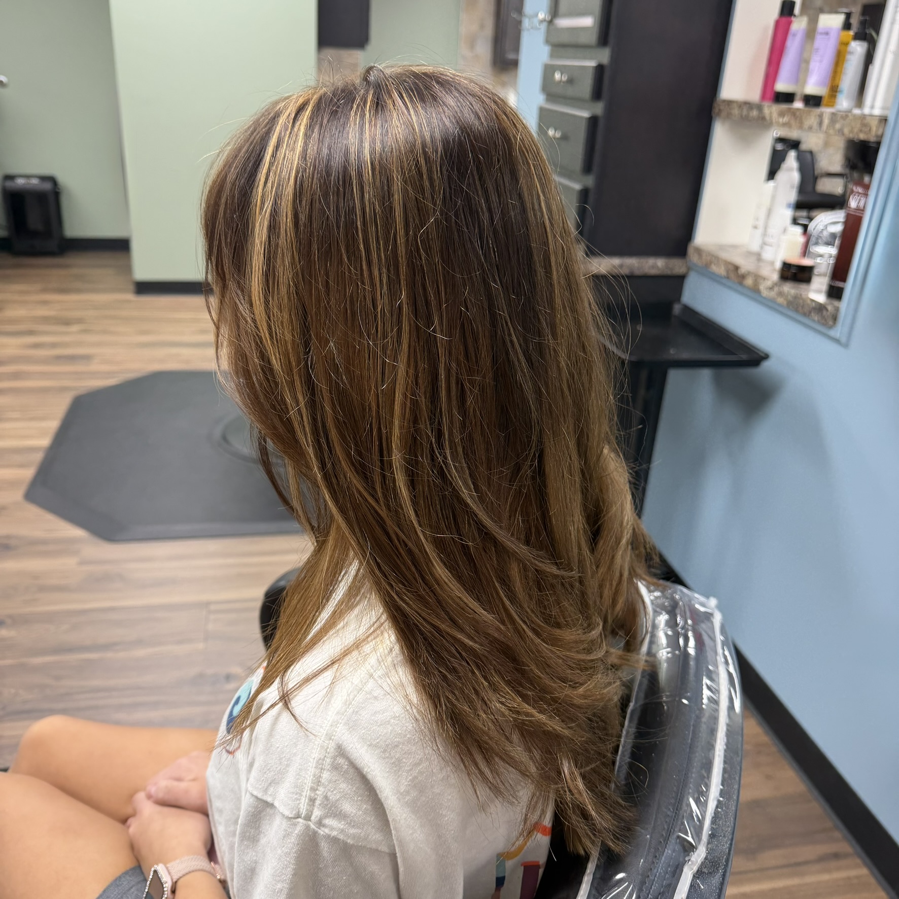 Long brunette with caramel highlights at Favero's Hair Salon
