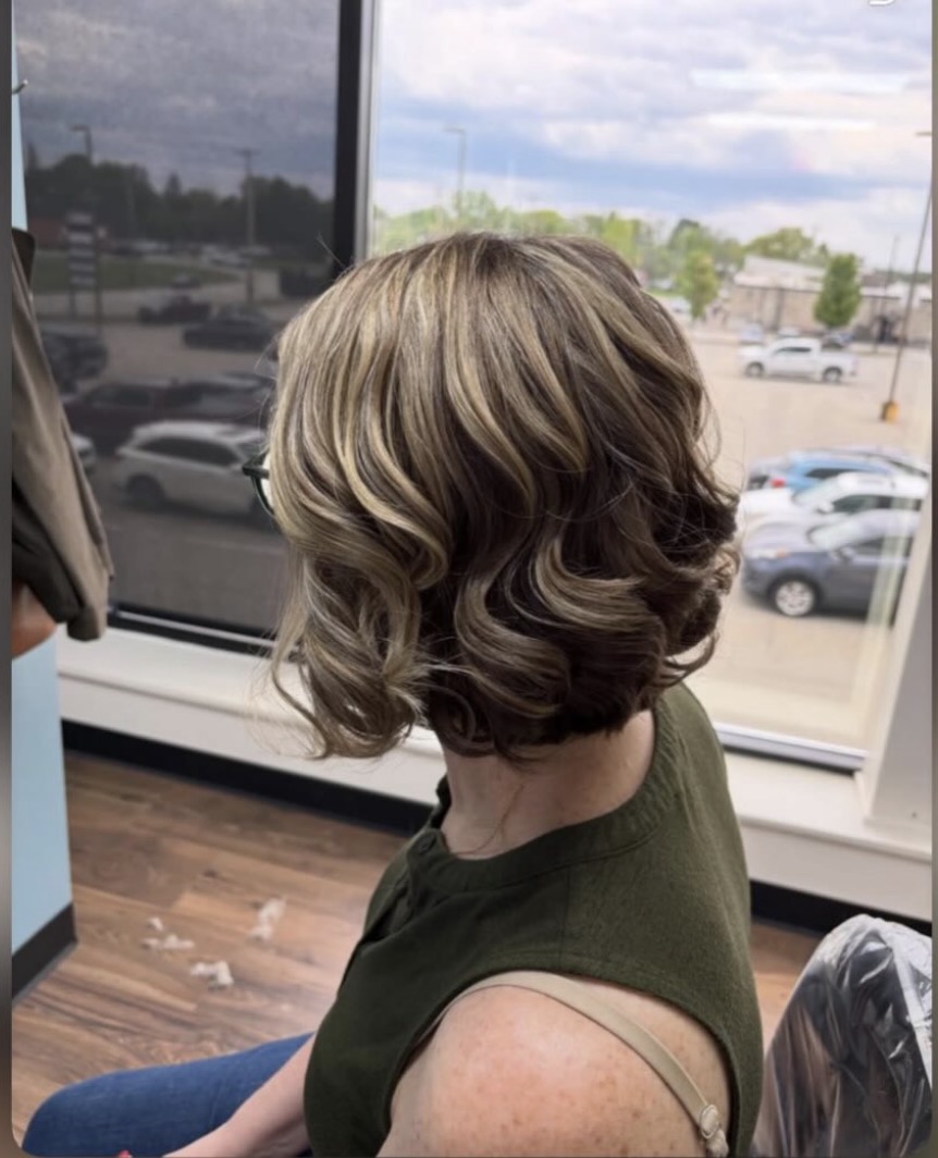 Short curled bob with blonde highlights at Favero's Hair Salon