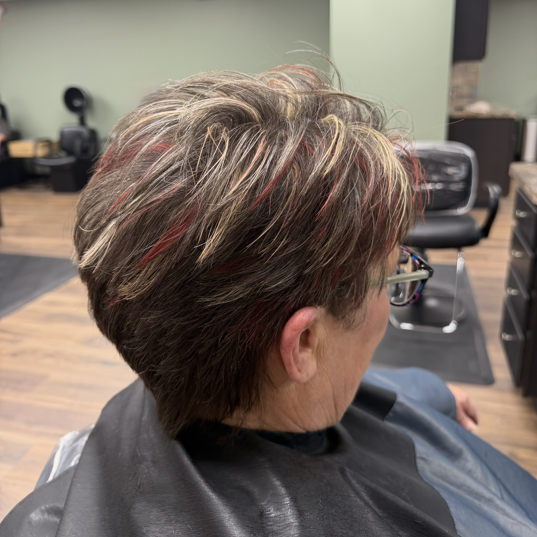 Short pixie with red and blonde highlights at Favero's Hair Salon
