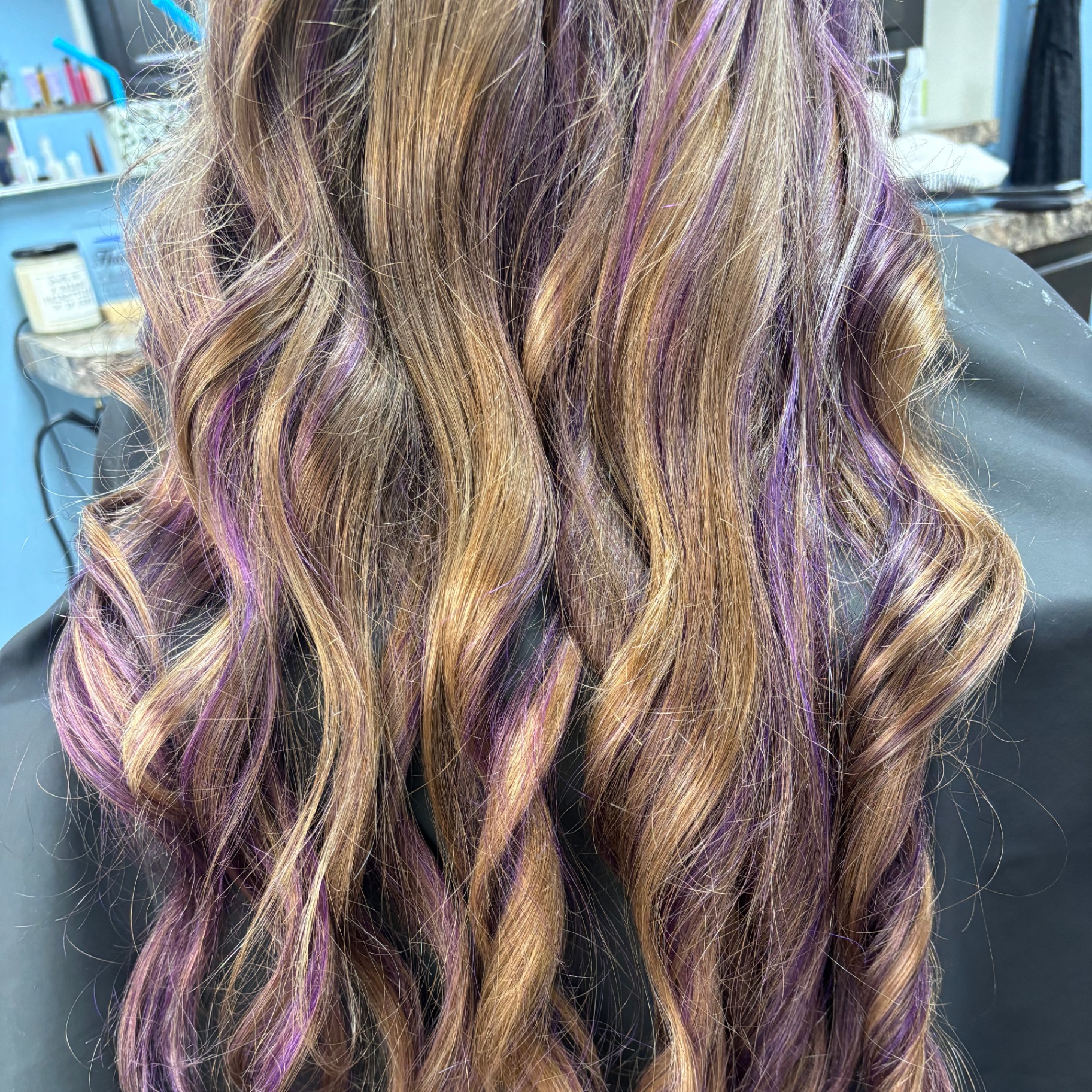 Long hair with purple fashion highlights at Favero's Hair Salon