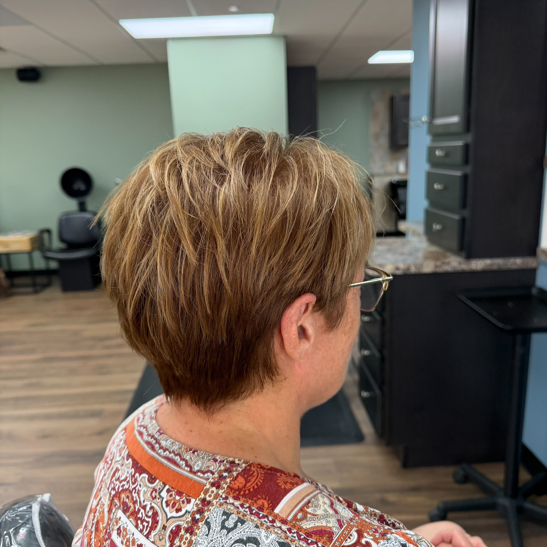 Short textured highlighted haircut at Favero's Hair Salon