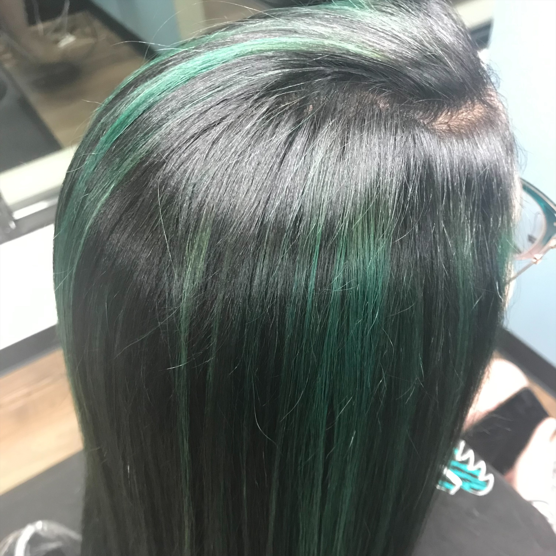 Dark hair with green fashion color at Favero's Hair Salon
